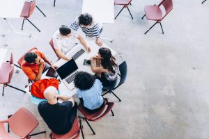 A picture of a group of young Brazilians working together on a project.