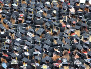 An image of students dressed in their graduation gowns and hats from above.