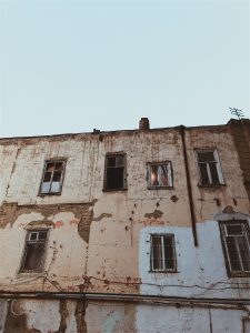 An image of the front of a dilapidated row of houses.